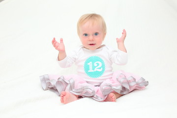 Close-up Portrait of Adorable Cute 12 Twelve Month Old baby Girl in Pink Tu-tu, Happy Baby, Isolated White Background, Twelve Month Sticker 