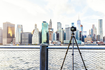 Camera, tripod set up outside outdoors in NYC New York City Brooklyn Bridge Park by east river,...
