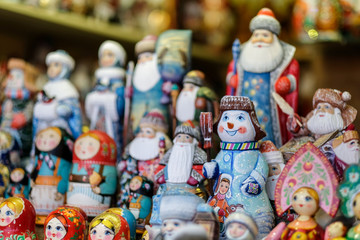 A lot of Matryoshka at souvenir market shop. Different colors Russian dolls. Traditional classic Russian handicraft art background. Famous classical and modern Russian dolls Matryoshka toys