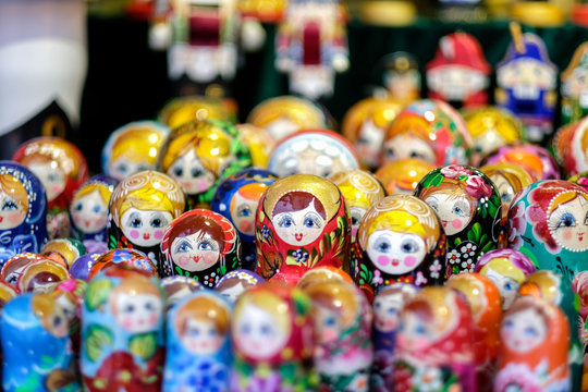 A lot of Matryoshka at souvenir market shop. Different colors Russian dolls. Traditional classic Russian handicraft art background. Famous classical and modern Russian dolls Matryoshka toys