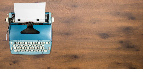 Old electric typewriter on wood background