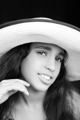 Portrait of a young african american girl laughing with sun hat