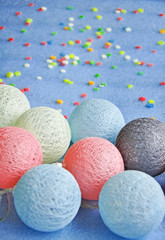 decorative balls in blue, white, gray and pink colors lie on a blue background