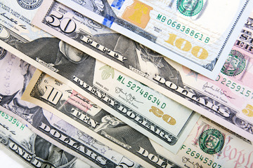 Fototapeta na wymiar A pile of US banknotes with president portraits. Cash of dollar bills, dollar background image