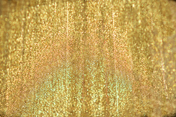 gold satin/ Background of mother-of-pearl bright yellow gold satin with shallow depth of field around the edges - obrazy, fototapety, plakaty