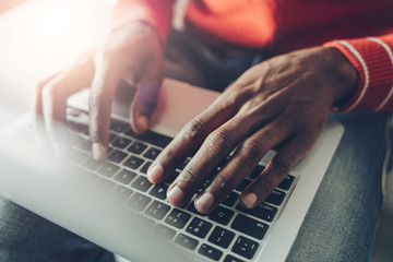 Close up of male arms touching laptop keyboard with fingers. Communication concept