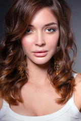 Naklejka premium Portrait of beautiful young woman face. Isolated on dark background.