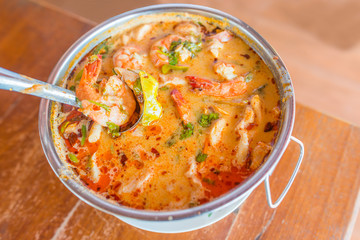 Tom Yum Koong  (Thai Language) is prawn and lemon grass soup with mushrooms the famous delicious Thai food.