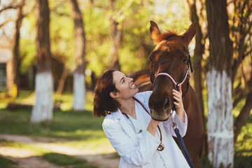 Veterinarian enjoying with a horse outdoors at ranch. 