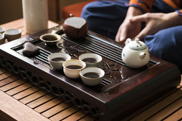 Fototapeta na wymiar Exquisite Hot Tea in Teapot at Traditional Chinese Tea Ceremony. Set of Equipment
