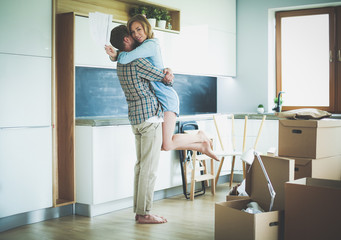 Portrait of young couple moving in new home. Young couple