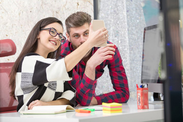 Business people making photos on mobile or smart phone and happy smiling. Workers having break time. Business concept.