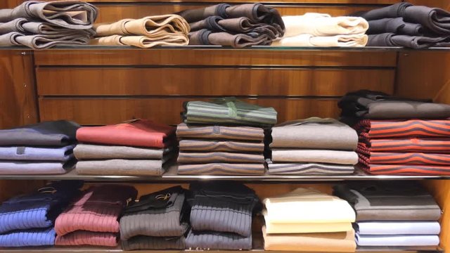 Showcase with pullovers in men's clothing store.