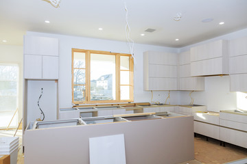 kitchen Cabinet with chipboard shelves with the door open on the hinge. Production of furniture production.
