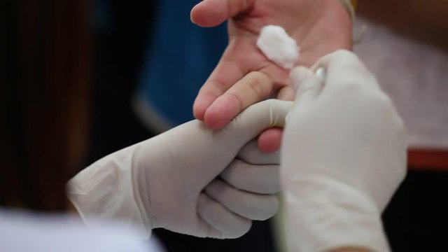 Health and Medical concept. Taking blood on finger for analysis test in clinical. Blood test is laboratory analysis performed on sample that usually extracted from vein in arm using hypodermic needle.