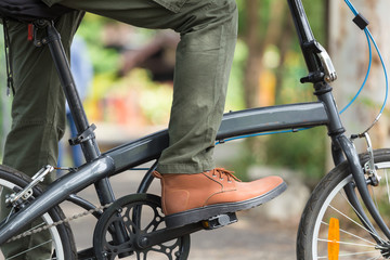 Man with cargo pants riding a bicycle in the garden