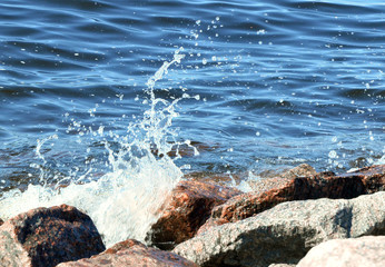 sea surf and wave splashing about coastal granite rocks