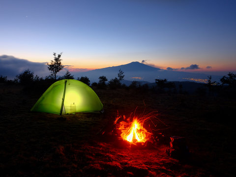 Lighting Tent, Campfire And Volcano Etna At Dawn, Sicily