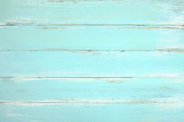Fototapeta premium Rocznika drewna plażowy tło - Stara wietrzejąca drewniana deska malująca w błękitnym kolorze.