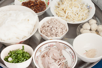 accessories for Thai noodles : Noodle,pepper,Pork,Pork Chops, Coriander,Meat ball,Deep fried garlic and beansprout Put in a bowl, place on stainless steel.