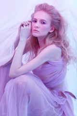 Naklejka premium Fashion portrait of young beautiful woman in fluffy violet dress.