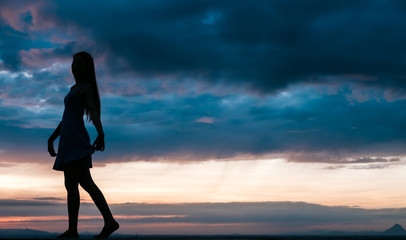 Fototapeta premium Young woman relaxing in summer sunset sky outdoor. People freedom style.
