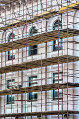 scaffolding built around a historic building for restoration work