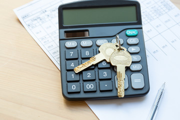 Home expenses,  key and calculator. Office desk. pen, calculator and keys