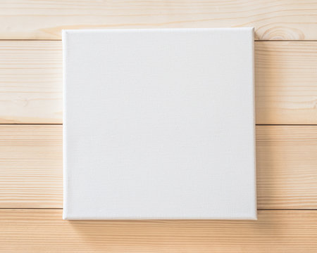 White blank canvas mockup square size on wood wall for arts painting and photo hanging interior decoration