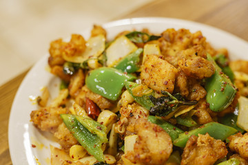 Close up shot of chicken with szechwan pepper and green pepper
