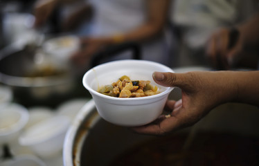 Feeding the poor to hands of a beggar. Poverty concept