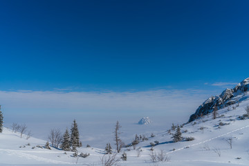Fototapeta na wymiar Schneelandschaft auf dem Berg - Tal im Nebel - Blick auf Traunstein