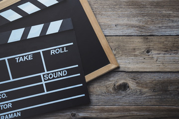 movie clapper on wood table ; film, cinema and vedio photography concept