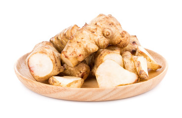 Jerusalem artichoke in wooden plate on white background