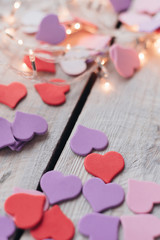 Background for design to Valentine's Day. Decorative red purple ultraviolet hearts. View from above. Valentines Day concept