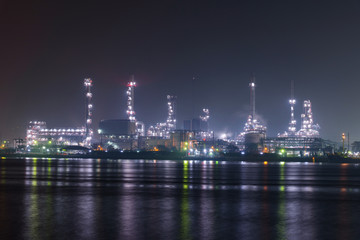 Fototapeta na wymiar Big factory at the river in night time 