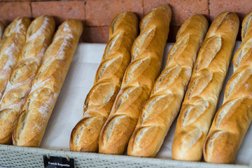 French baguettes on basket in bakery, ready to sell.