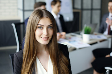 business woman with her staff, people group in background at modern bright office indoors.