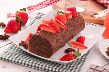 Chocolate roll with strawberries. 