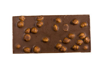 Milk chocolate bar with hazelnuts isolated on white background