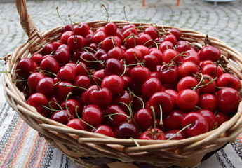 Cherries. Cherry. Organic cherries in basket on a farmer’s market. Red cherry background. Fresh cherries texture. Healthy food concept. 