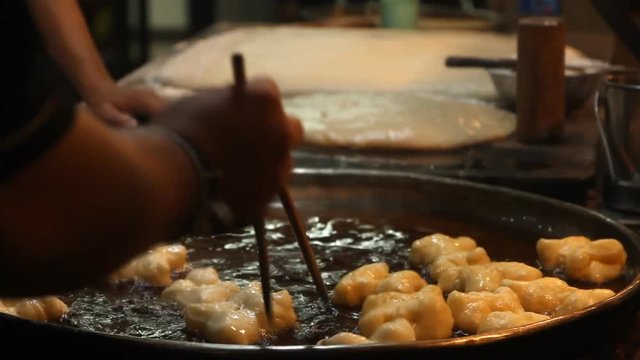 Chef preparing Fried Bread Stick, (youtiao, patongko, Banh Quay)