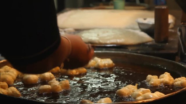 Chef preparing Fried Bread Stick, (youtiao, patongko, Banh Quay)