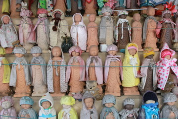 Fototapeta premium Buddhas wearing cloths in Yamadera temple in Yamagata, Japan