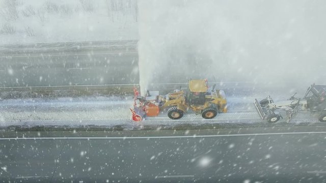 Heavy big storm snow fall, grader clean remove snow, snowplow, snow blower, blast snowfall, winter, road, special vehicle on the highway, cool frozen fountain of snow aerial view