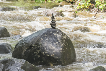 stone cairn, stack on a rock in the river
