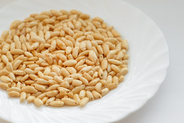 Puffed rice in white cup on white background.