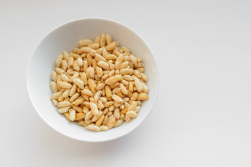 Puffed rice in white cup on white background.