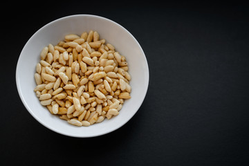 Puffed rice in white cup on dark background.