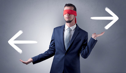 Covered eye businessman choosing direction